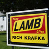Sign reading 'Enjoy Lamb Often - Rich Krafka' in front of a white house